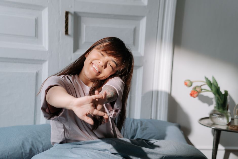 Woman waking peacefully in morning light